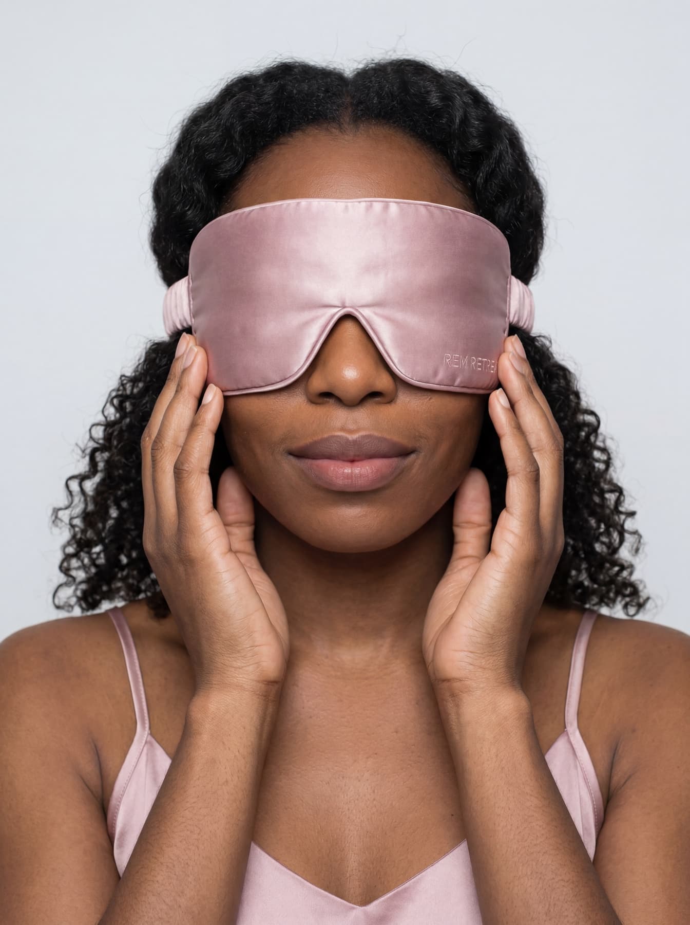 On-model portrait featuring the REM Retreat hush pink sleep mask