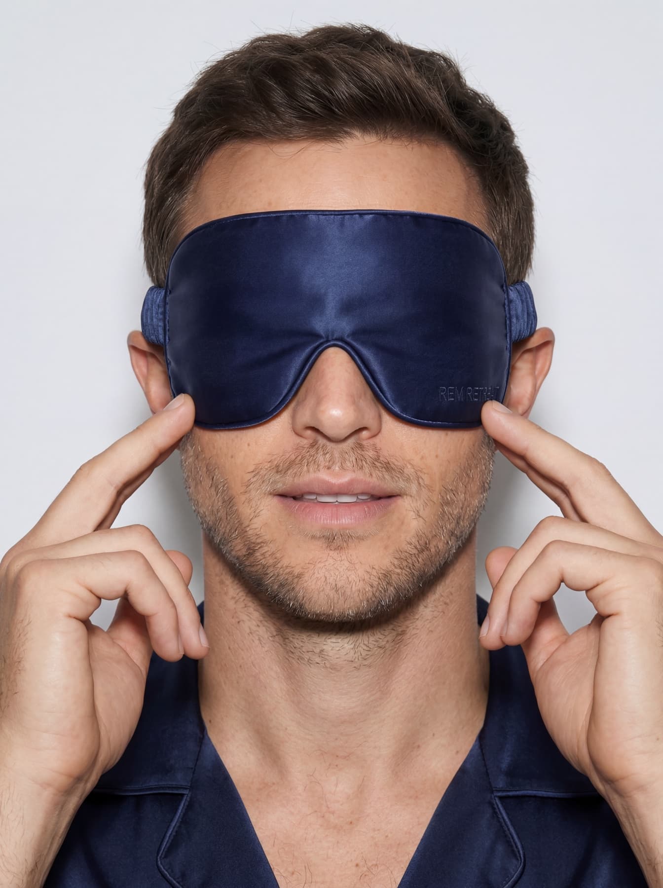 Male portrait featuring the REM Retreat midnight blue sleep mask