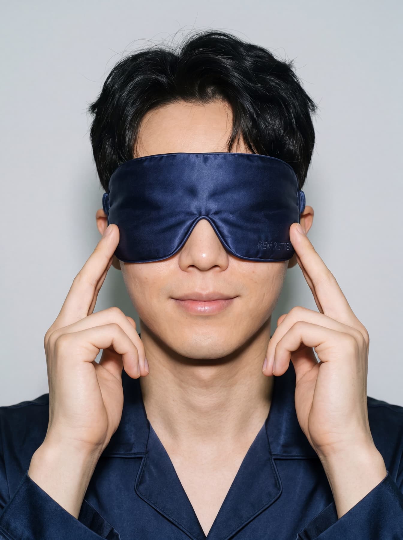 Lifestyle portrait featuring the REM Retreat midnight blue sleep mask