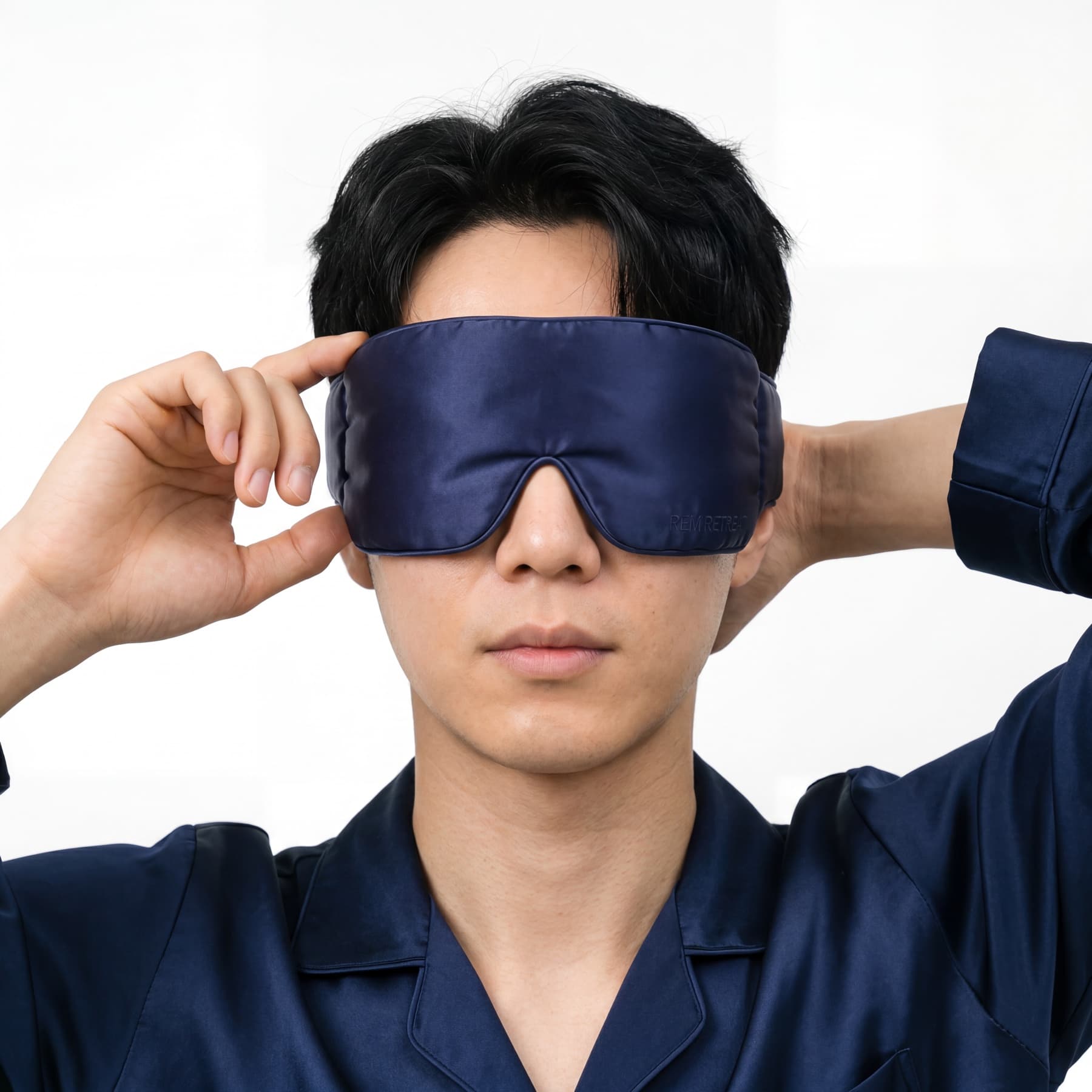Symmetrical on-model portrait featuring the REM Retreat midnight blue sleep mask