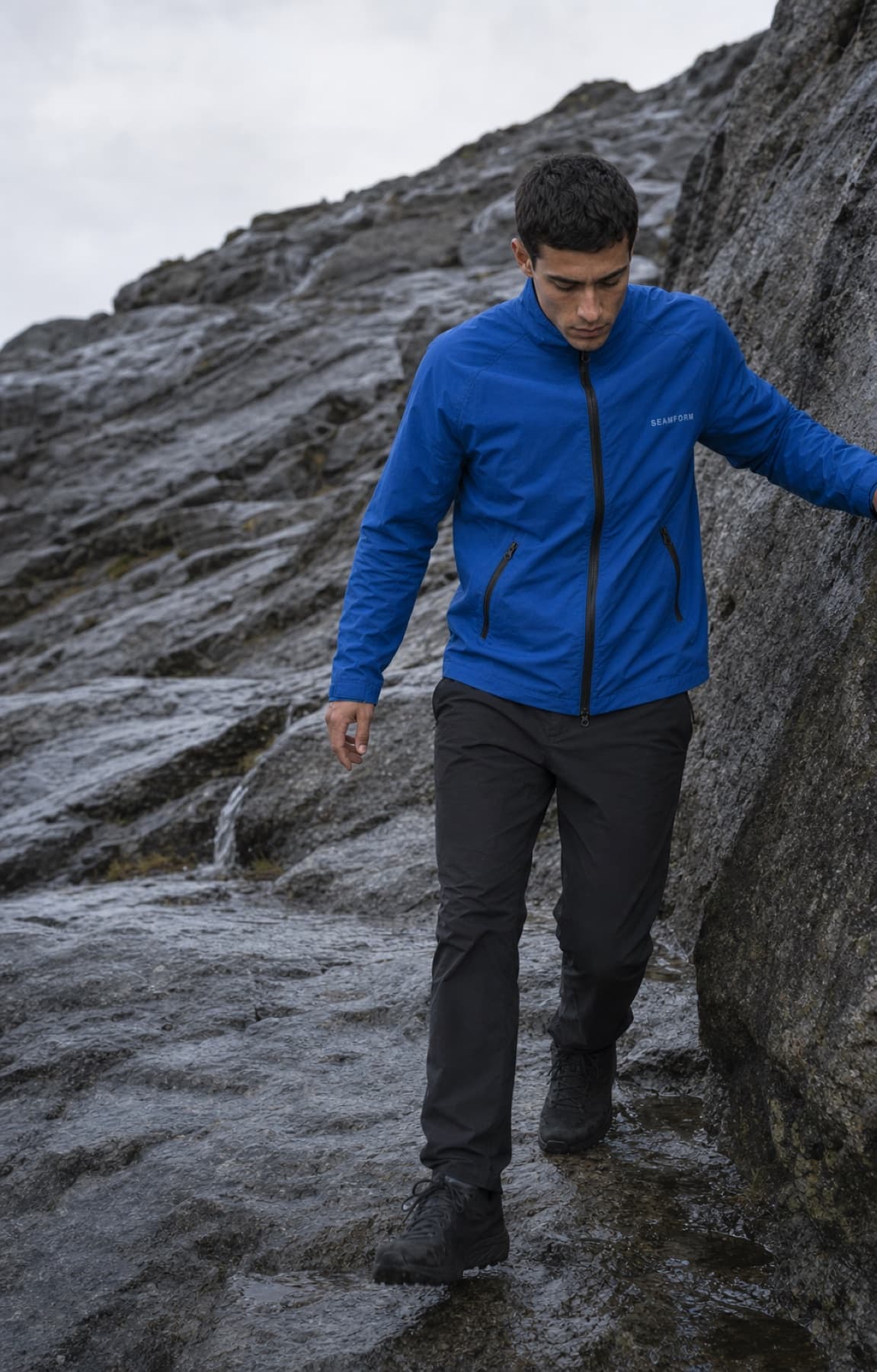 Seamform technical shell worn while scrambling over wet granite