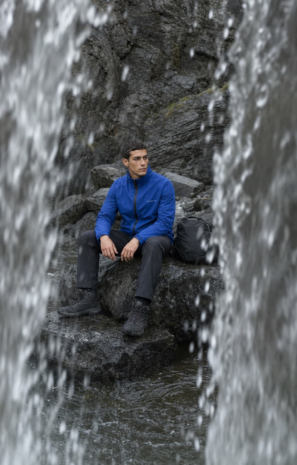 Seamform technical shell photographed behind a waterfall