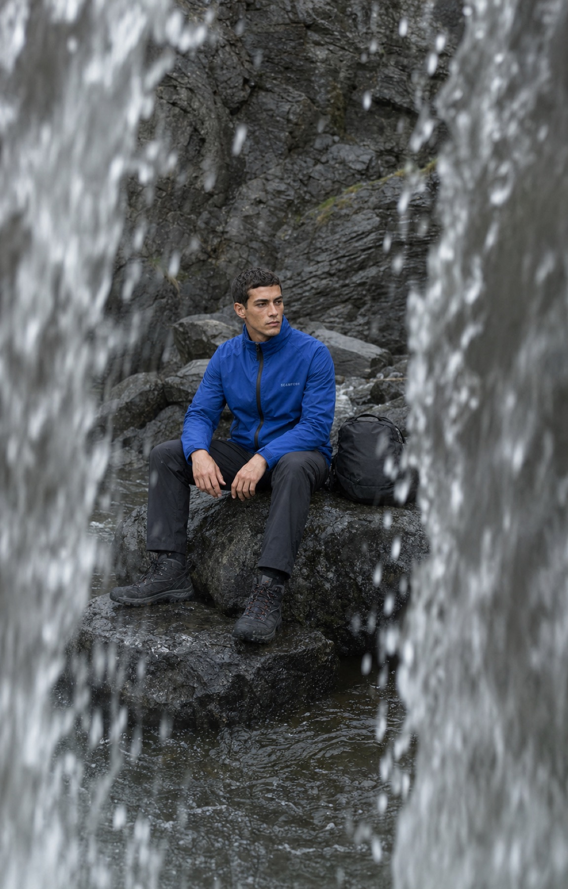 Seamform technical shell photographed behind a waterfall